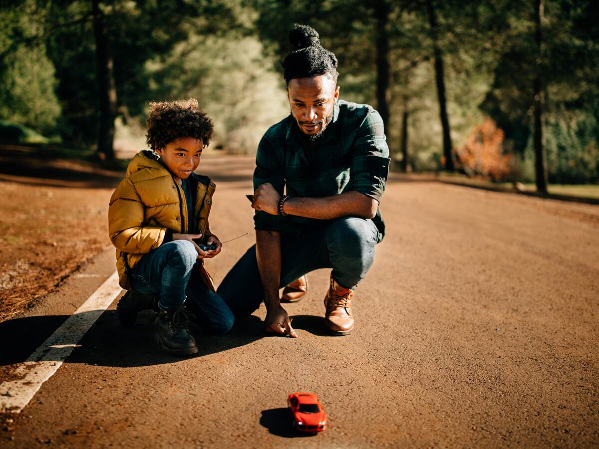 Father and son watch a radio-controlled car together
