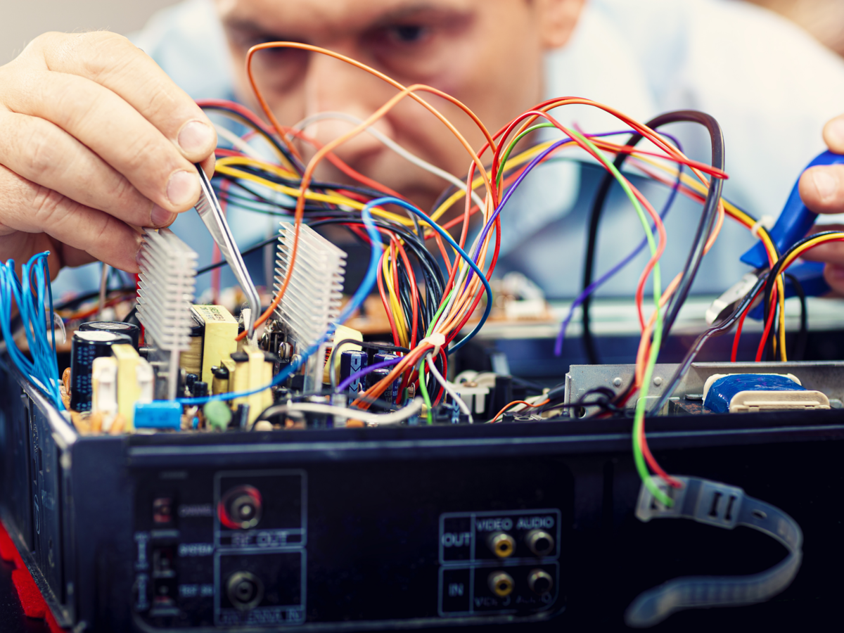 Electronics engineer repairs an audio/video device