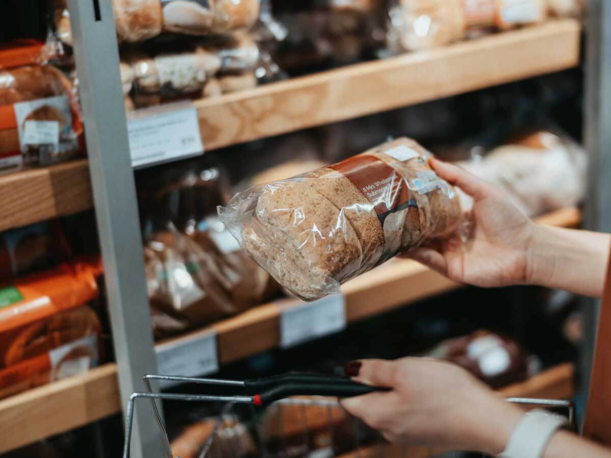 person's hand holding a packaged bread product