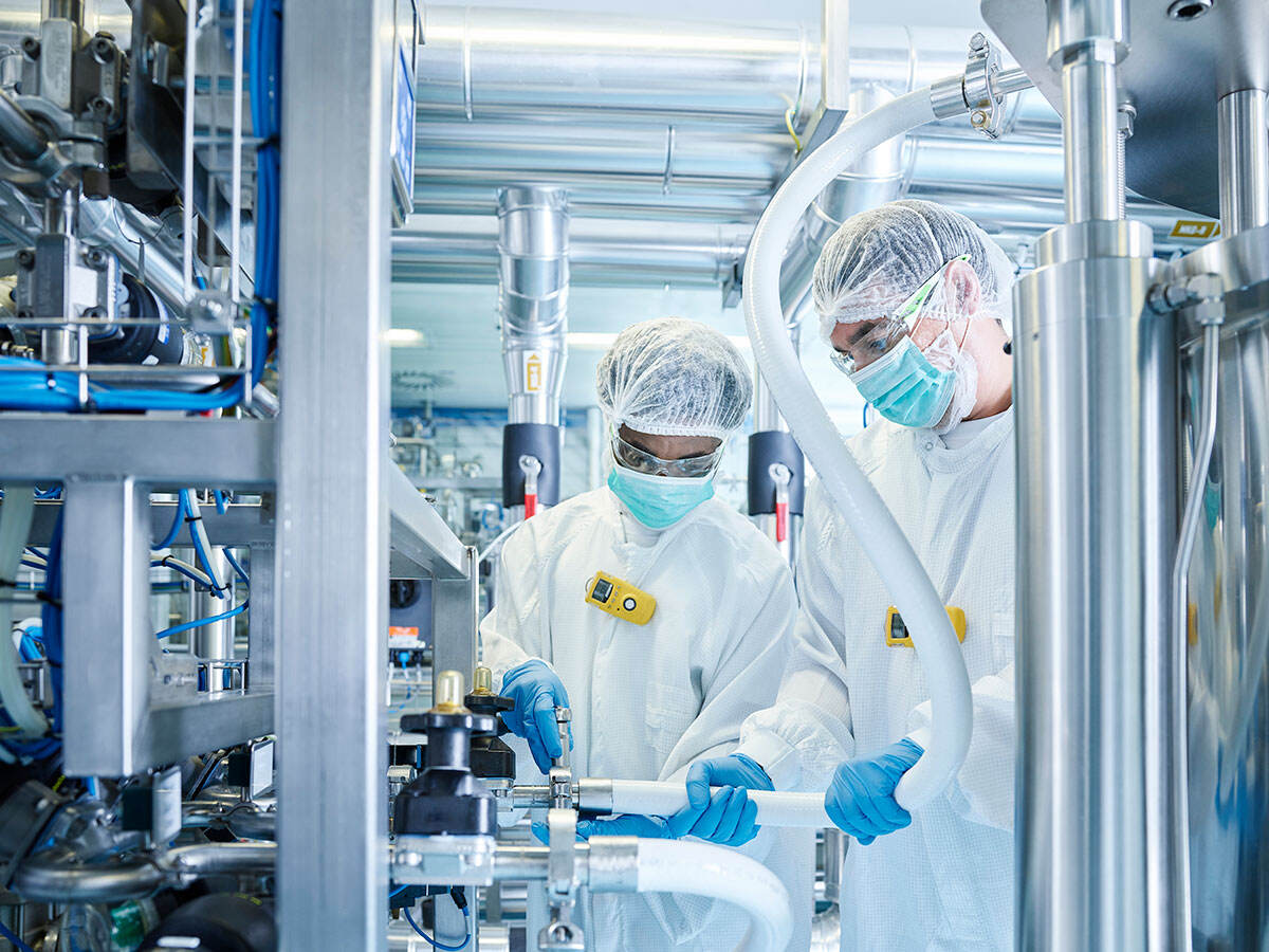 Laboratory technicians fitting a hose