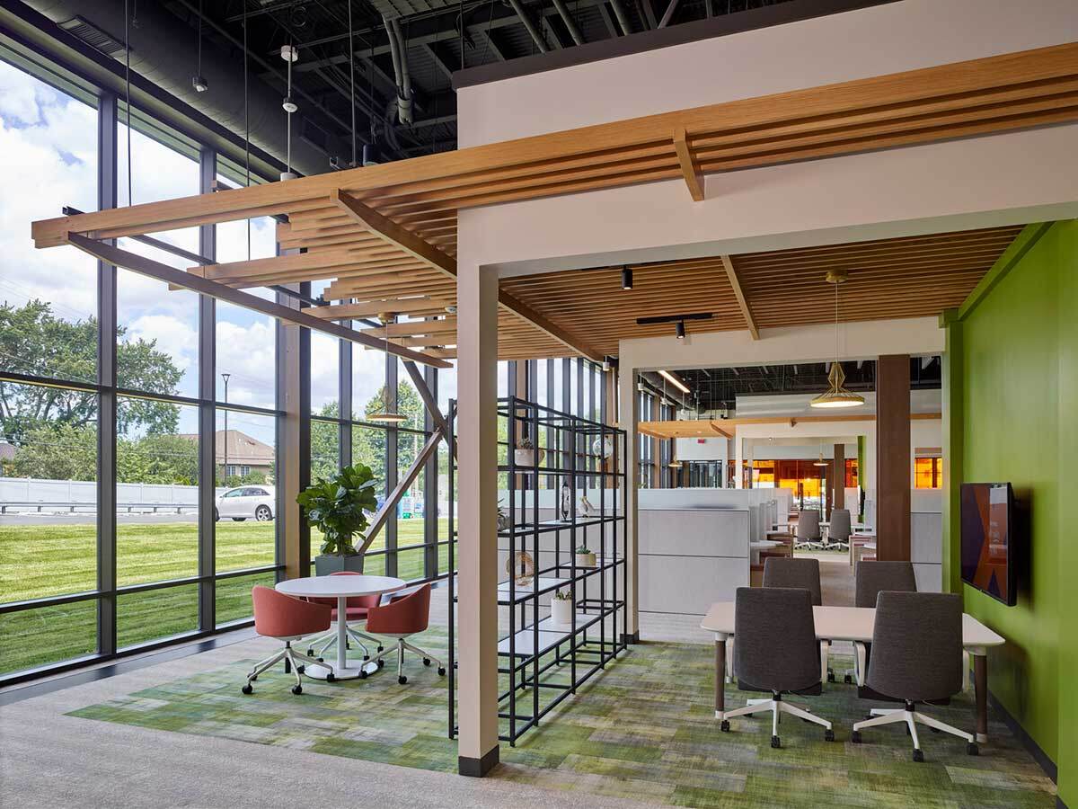 Brixmor interior with comfortable seating, showing windows and greenery outside