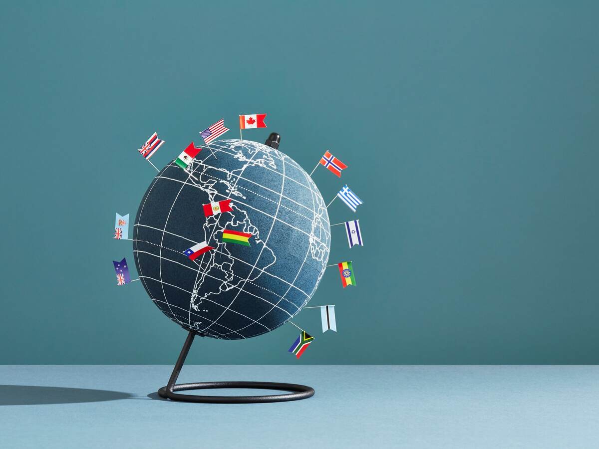 Globe of the world, with various country flags.