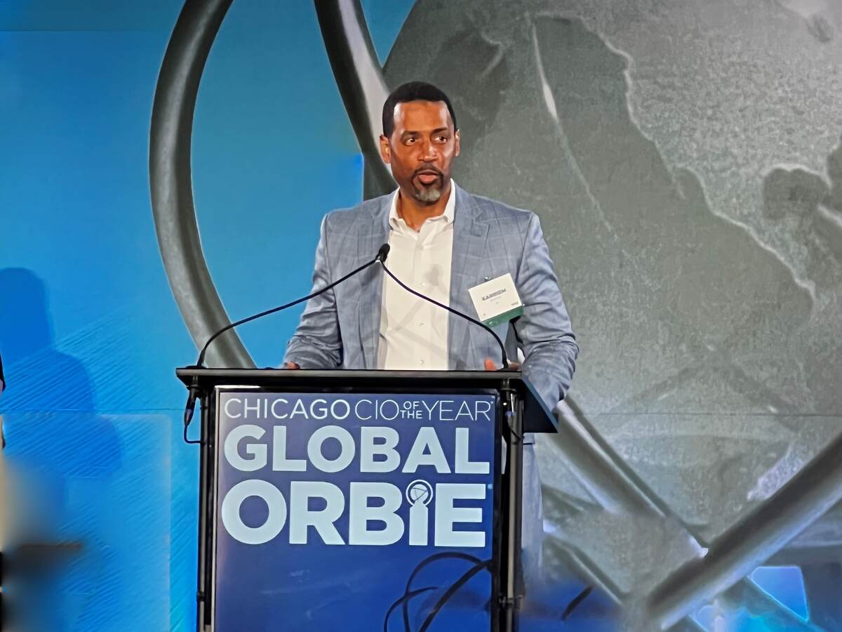 Karriem Shakoor speaks on stage at ORBIE awards ceremony from behind podium. 
