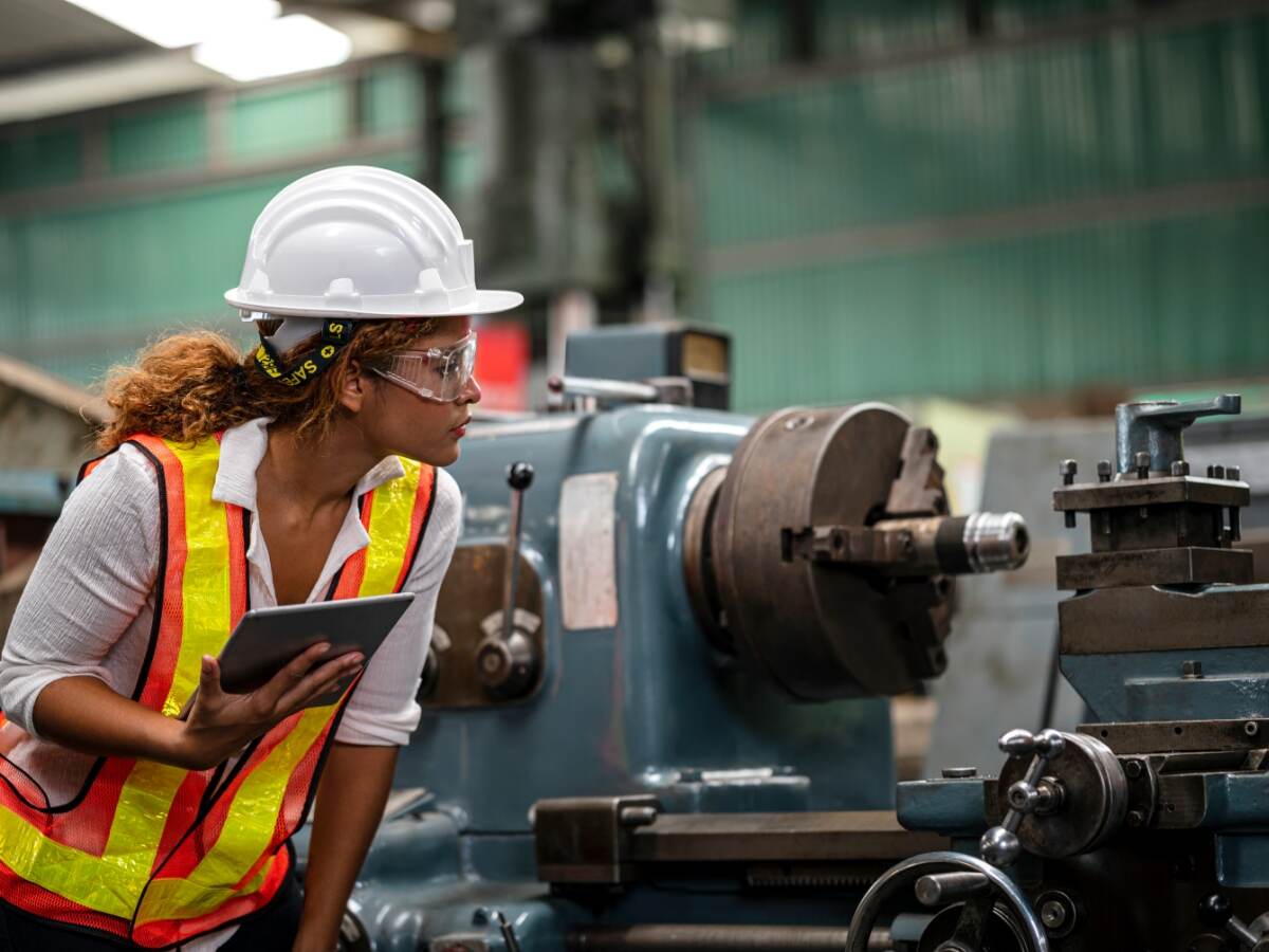 Quality control engineer observing machine