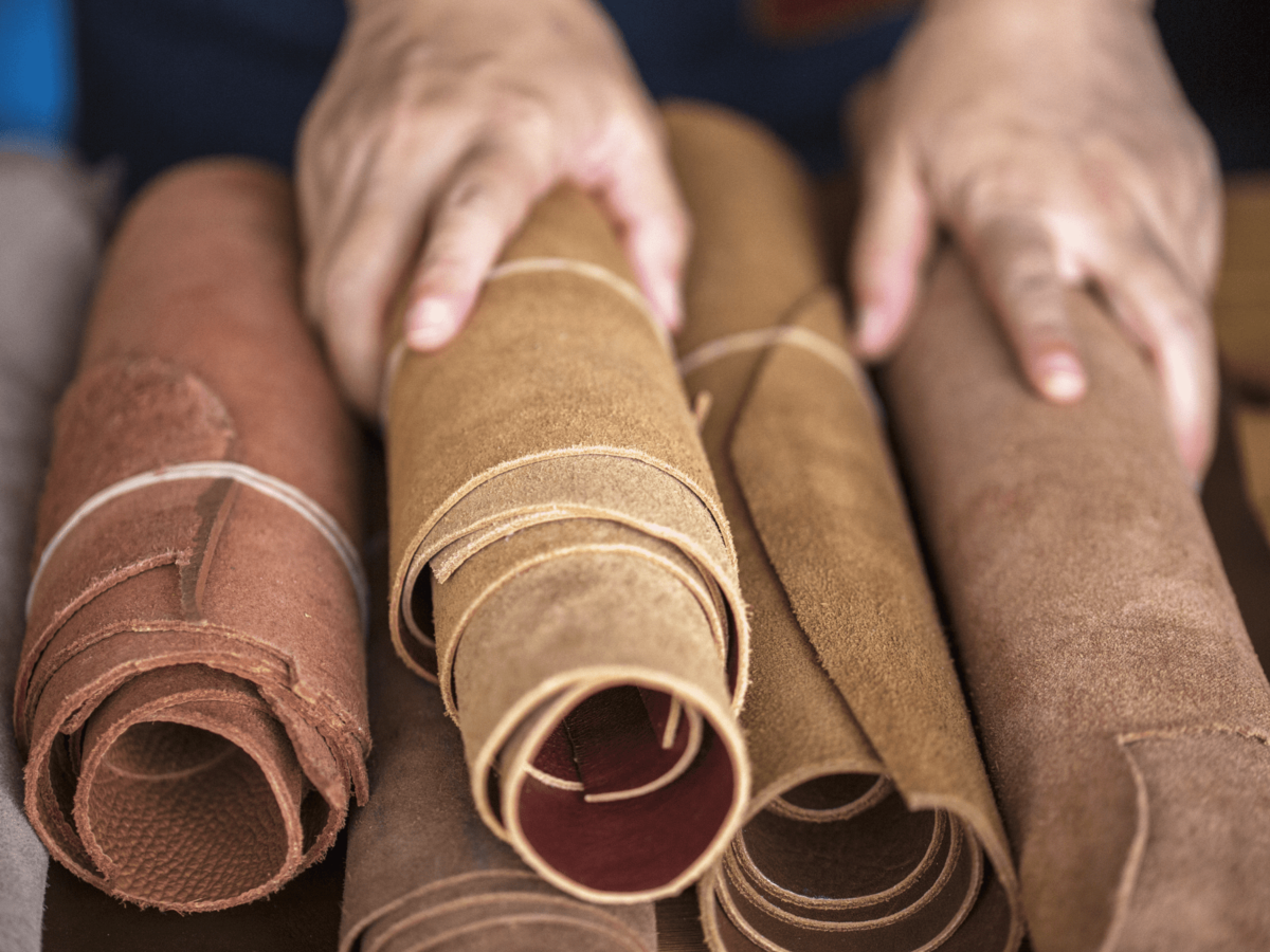 Rolls of leather of varying shades of brown stacked on top of each other