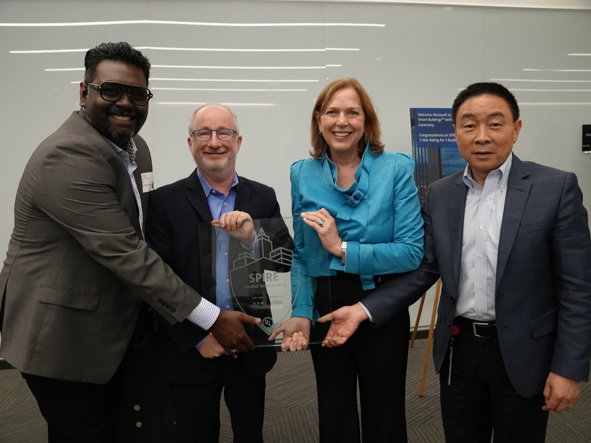 Microsoft and UL leadership hold a glass SPIRE Rating plaque