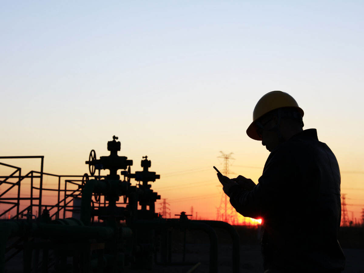 silhouette of a worker reviewing his data at dusk