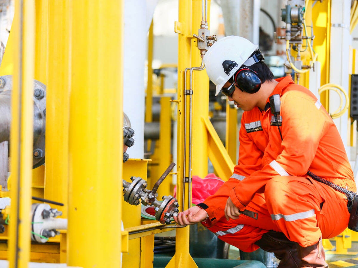 Worker checking pipes