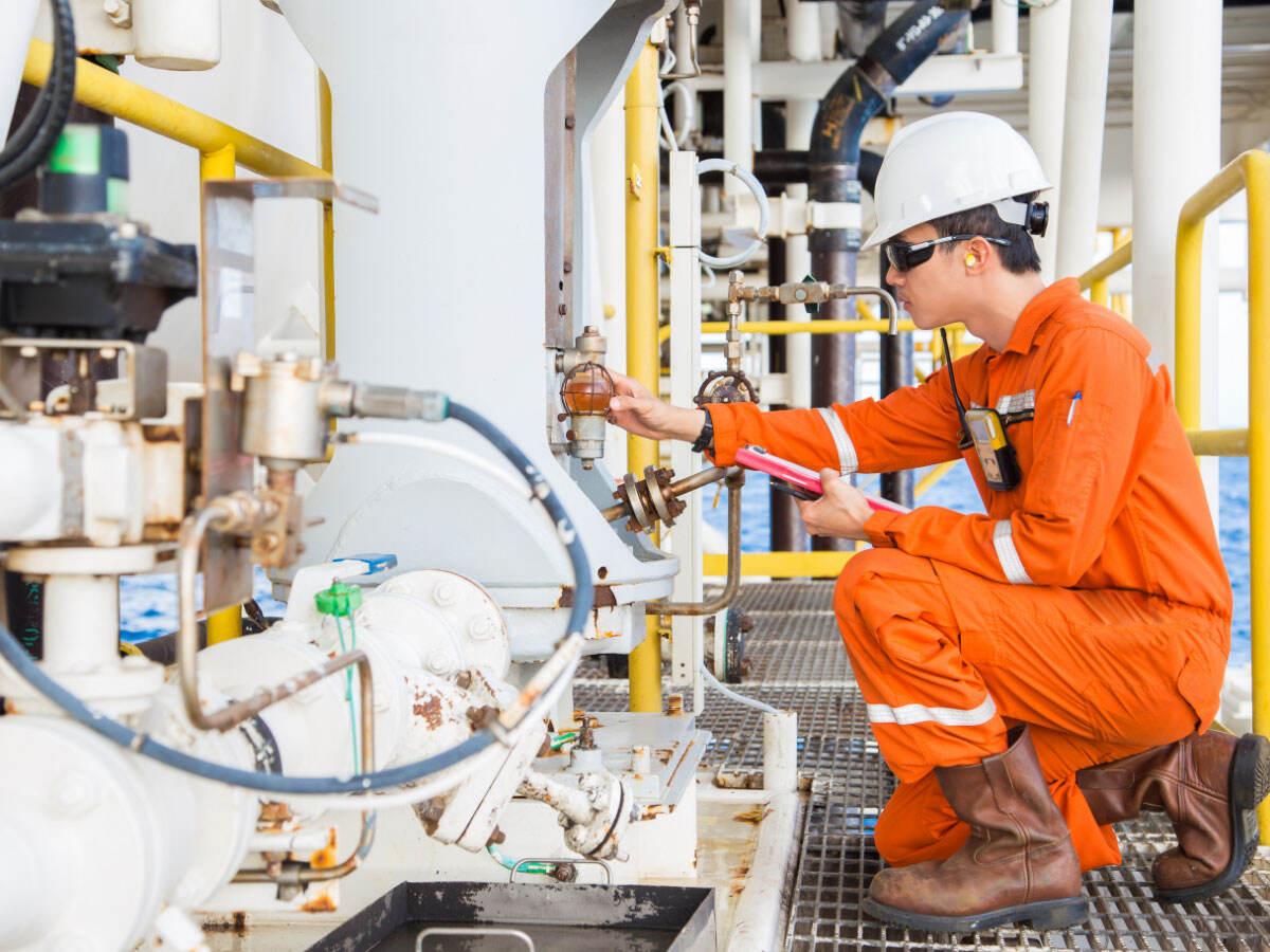 Worker checking pipes