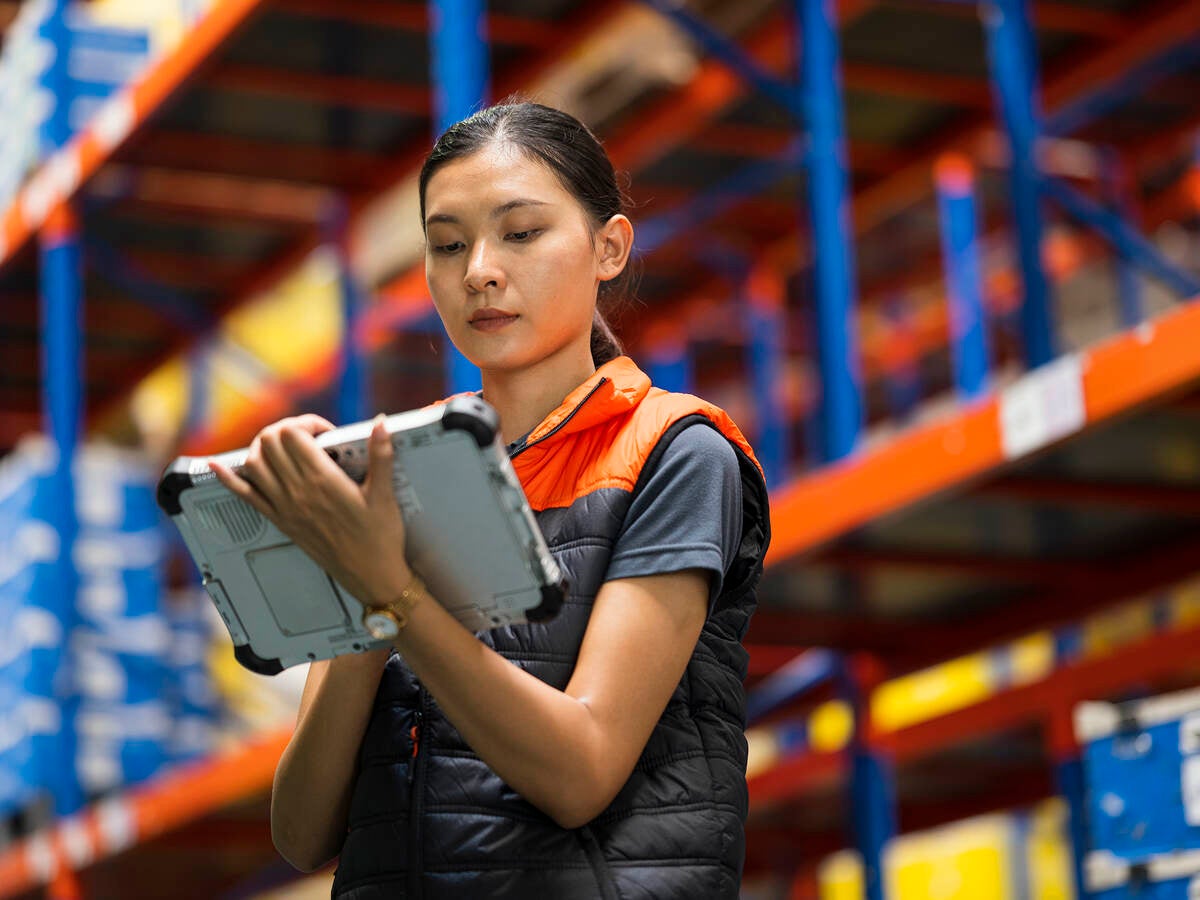 Worker checking inventory in a warehouse