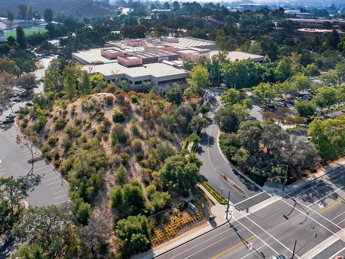An aerial view of a building surrounded by trees.
