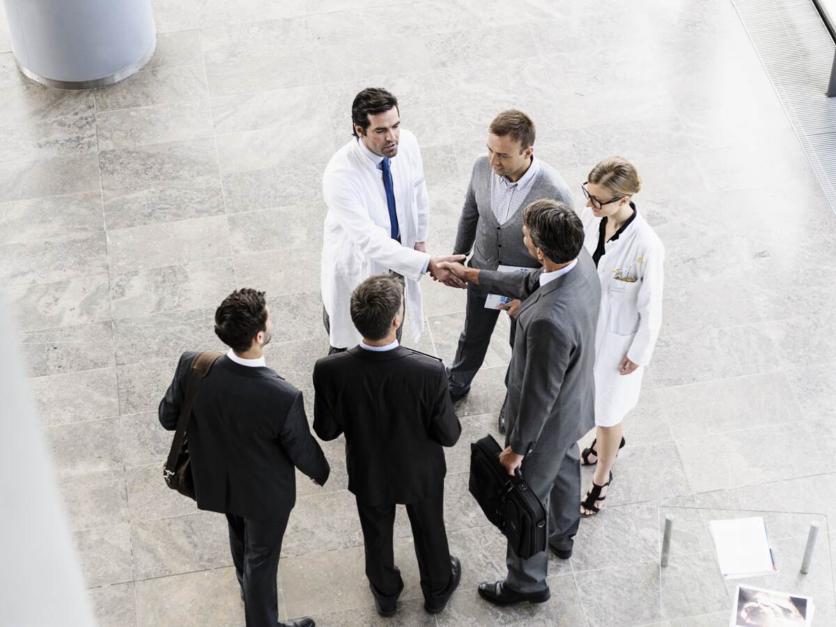 Businesspeople and doctors greeting