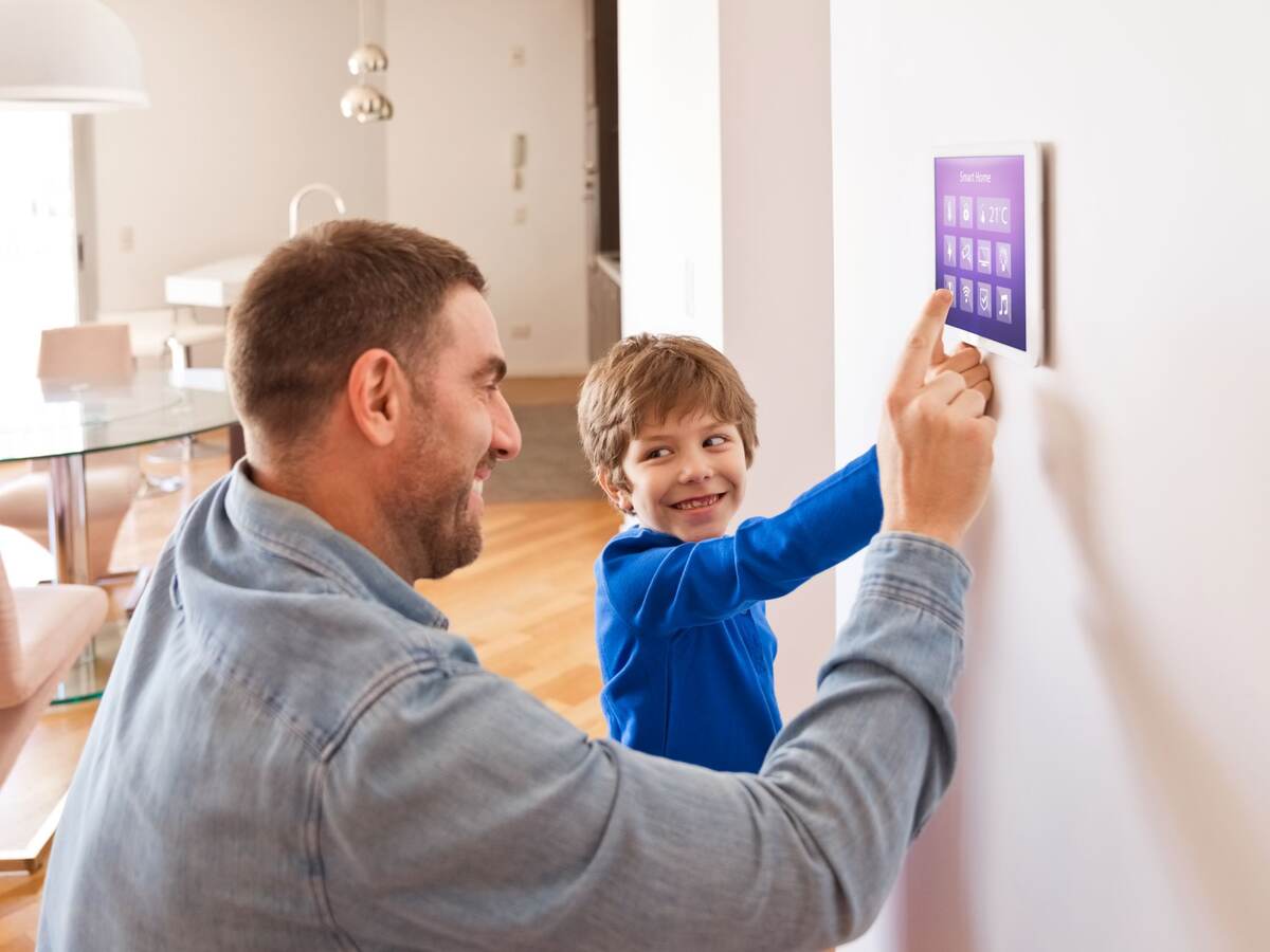 Father and his child are touching a IoT device.
