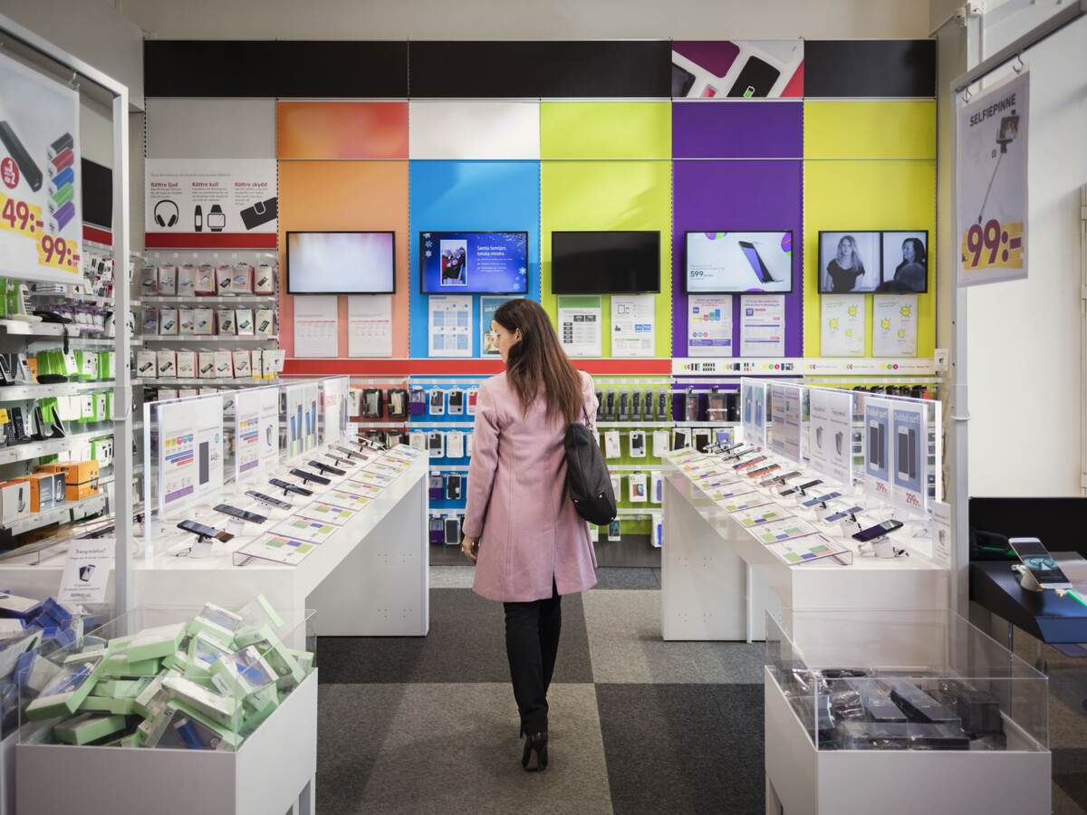 Woman browses products in an electronics store.