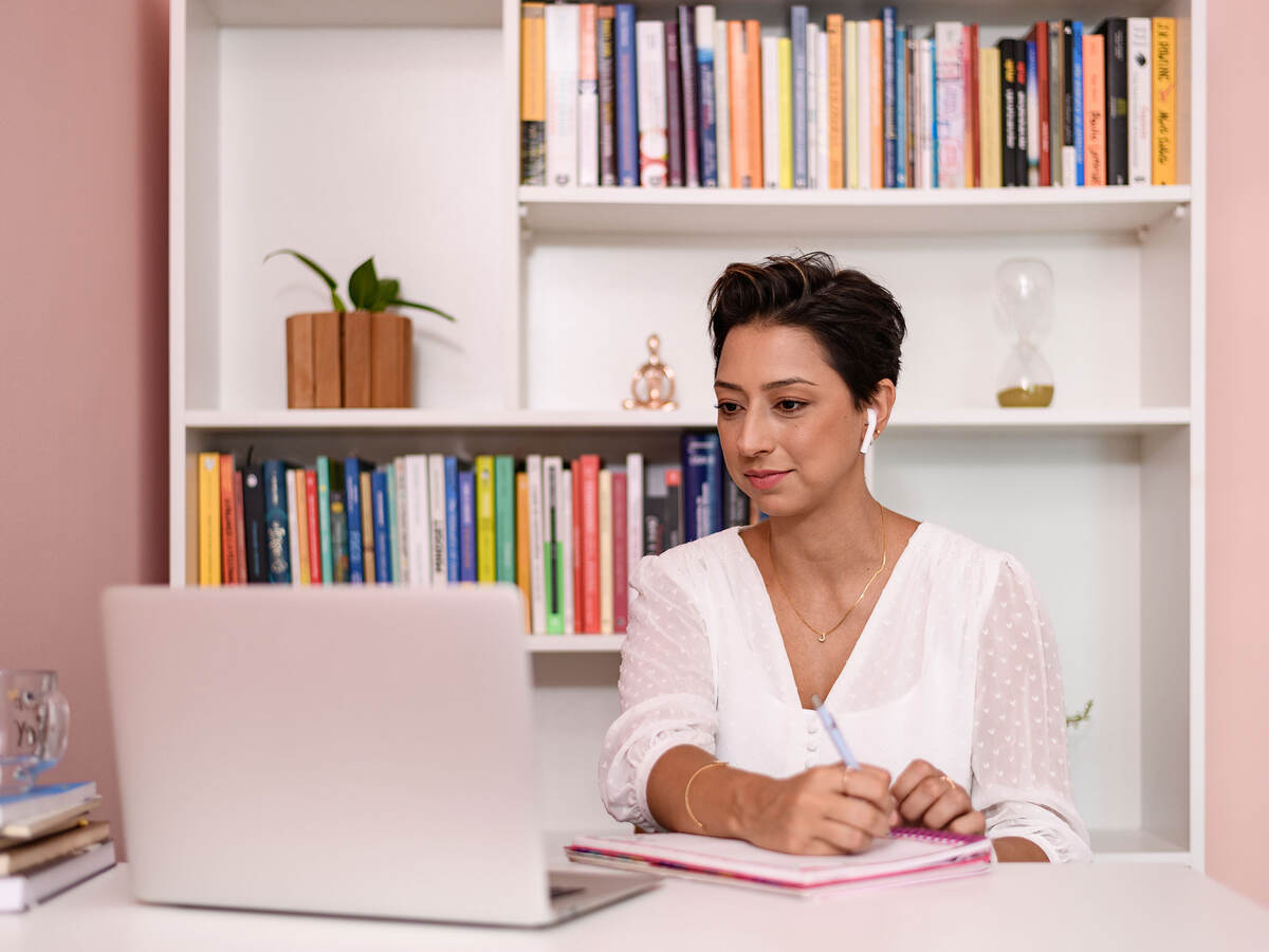 Person taking notes on a video call