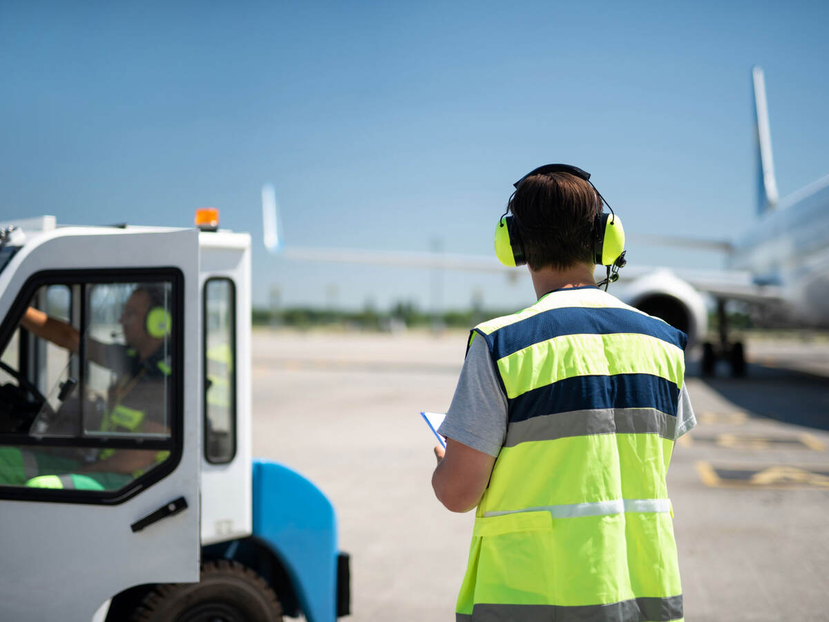 airport worker working with Lithium-ion battery-powered ground support vehicle