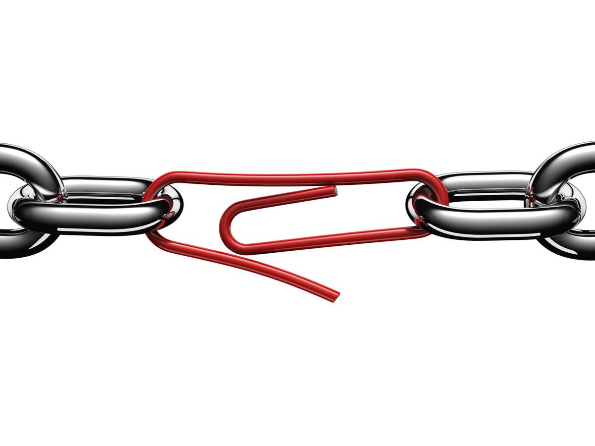 Steel chain links connected by a strained red paper clip.