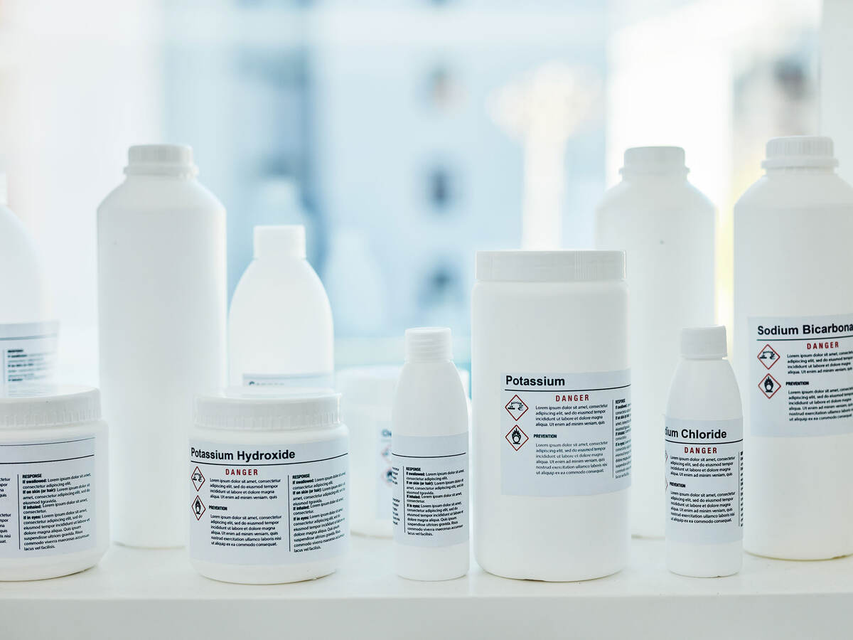 white bottles of chemicals on a shelf