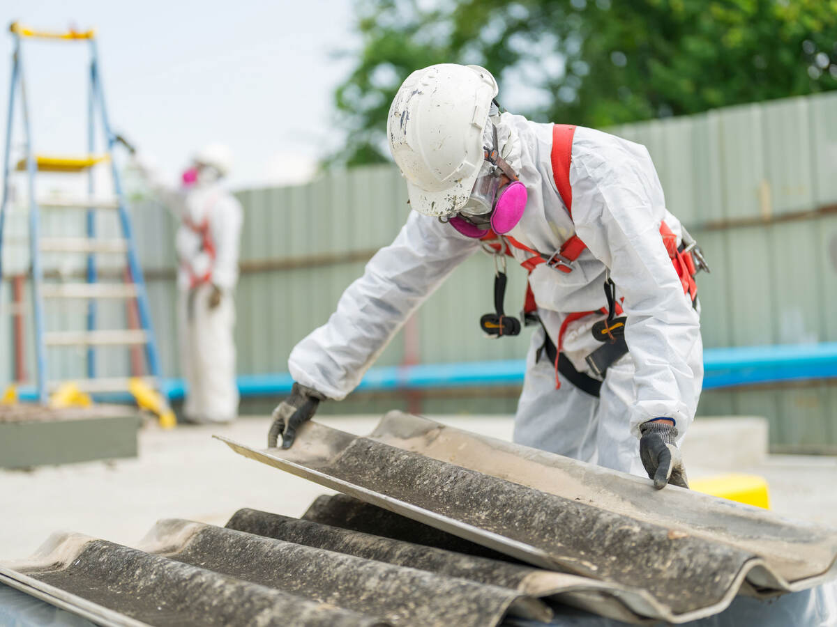An employee follows the correct safety procedure while handling asbestos. 
