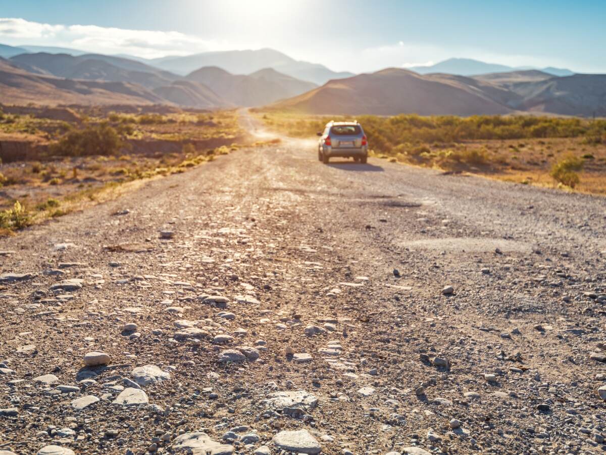 SUV on a dirt mountain.
