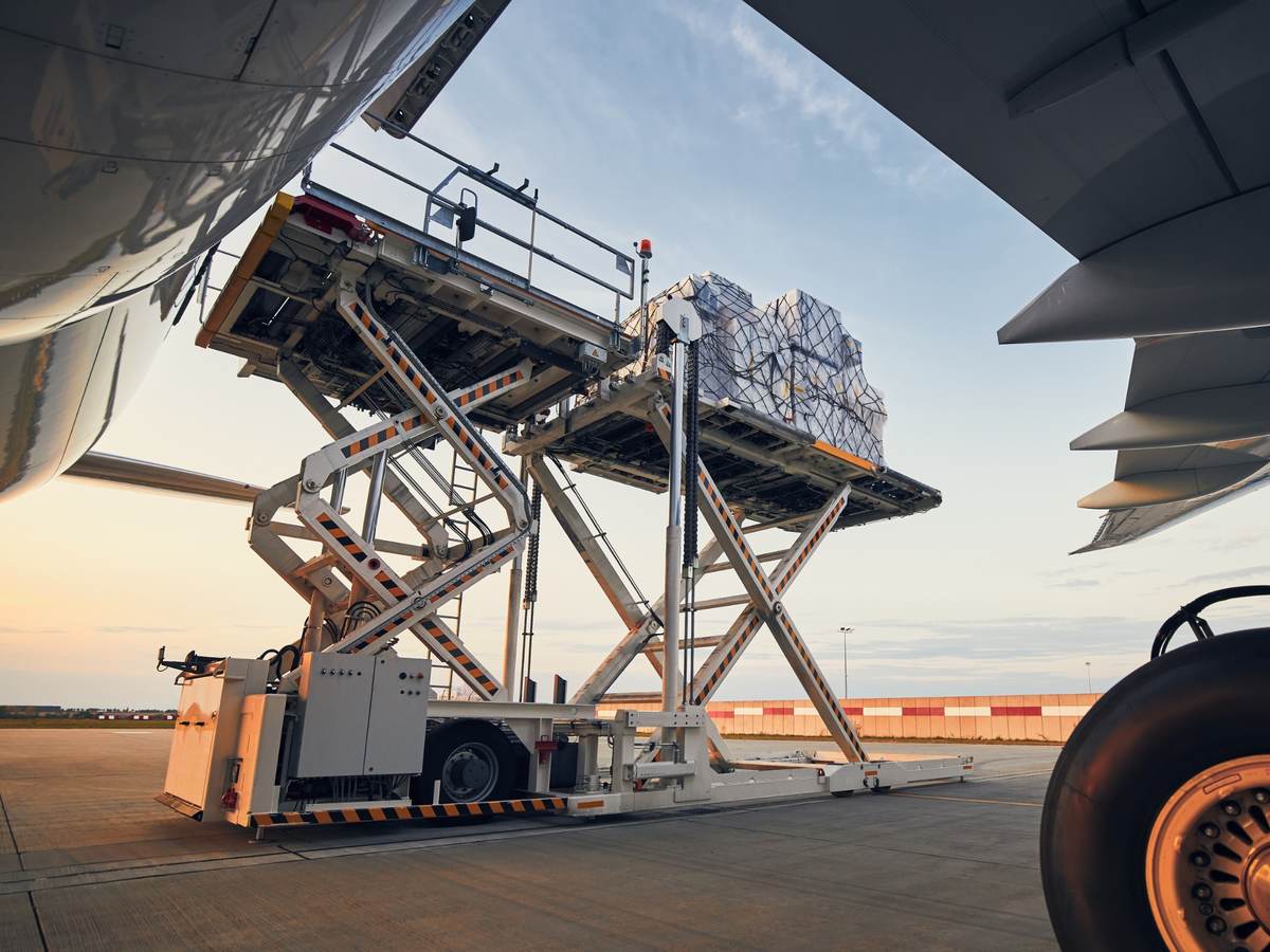 loading cargo containers onto an airplane