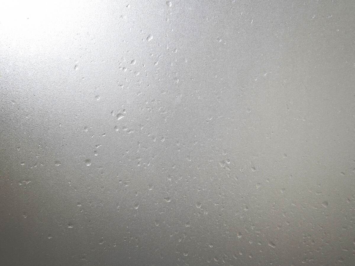Frosted glass with water drops.