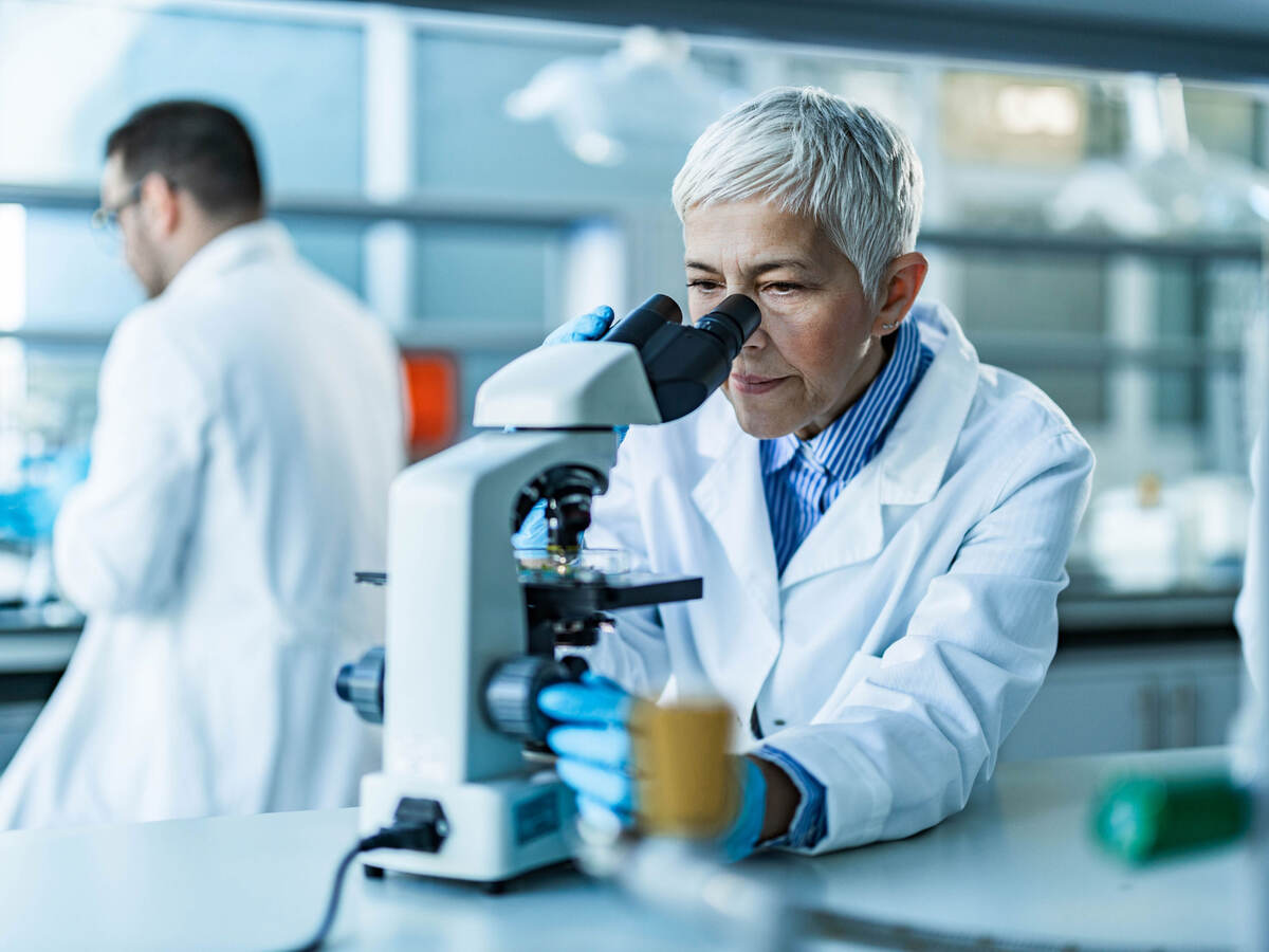 Scientist working on a microscope