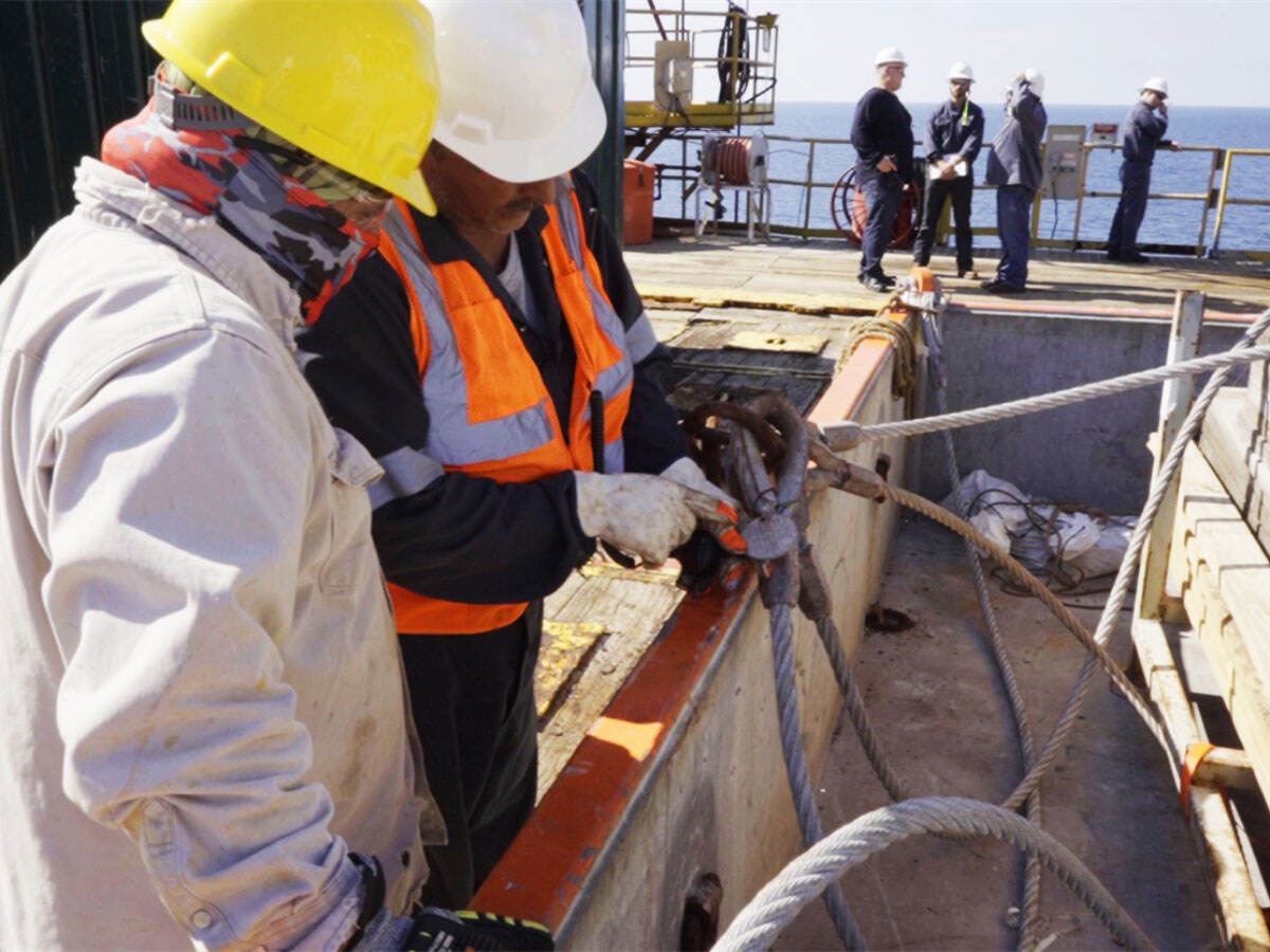 two people on an oil rig working together