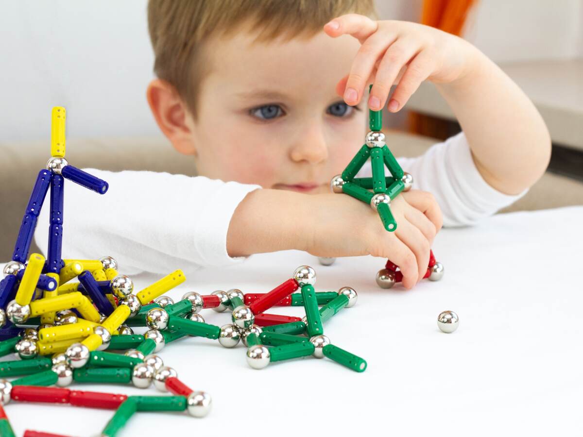 Boy playing with a toy magnets.
