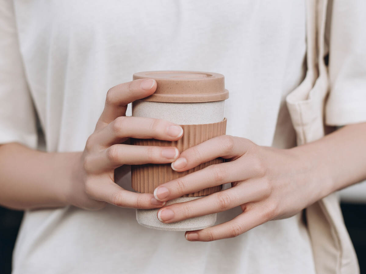 A person holding a coffee mug