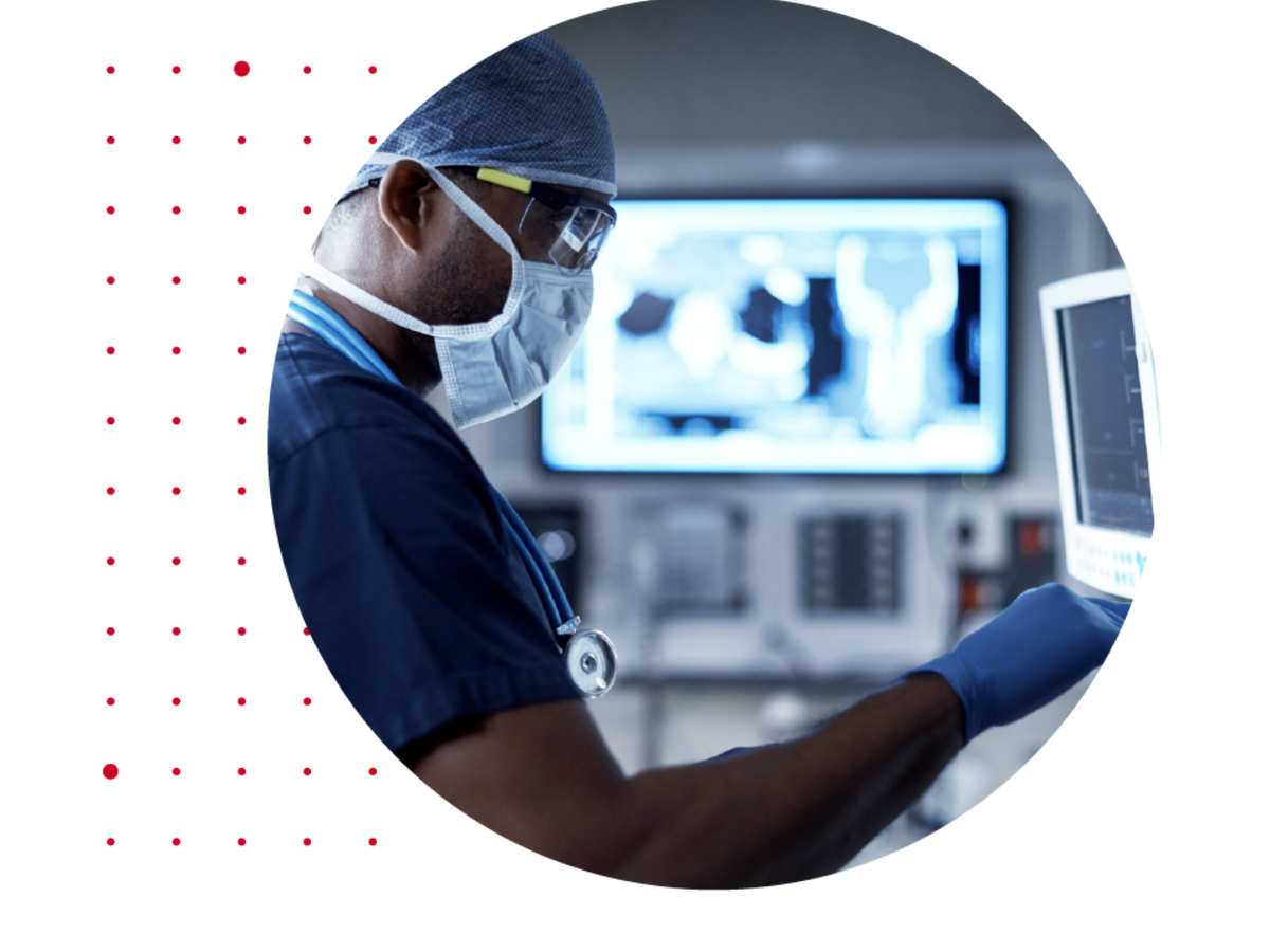 Surgeon looking at a health monitor