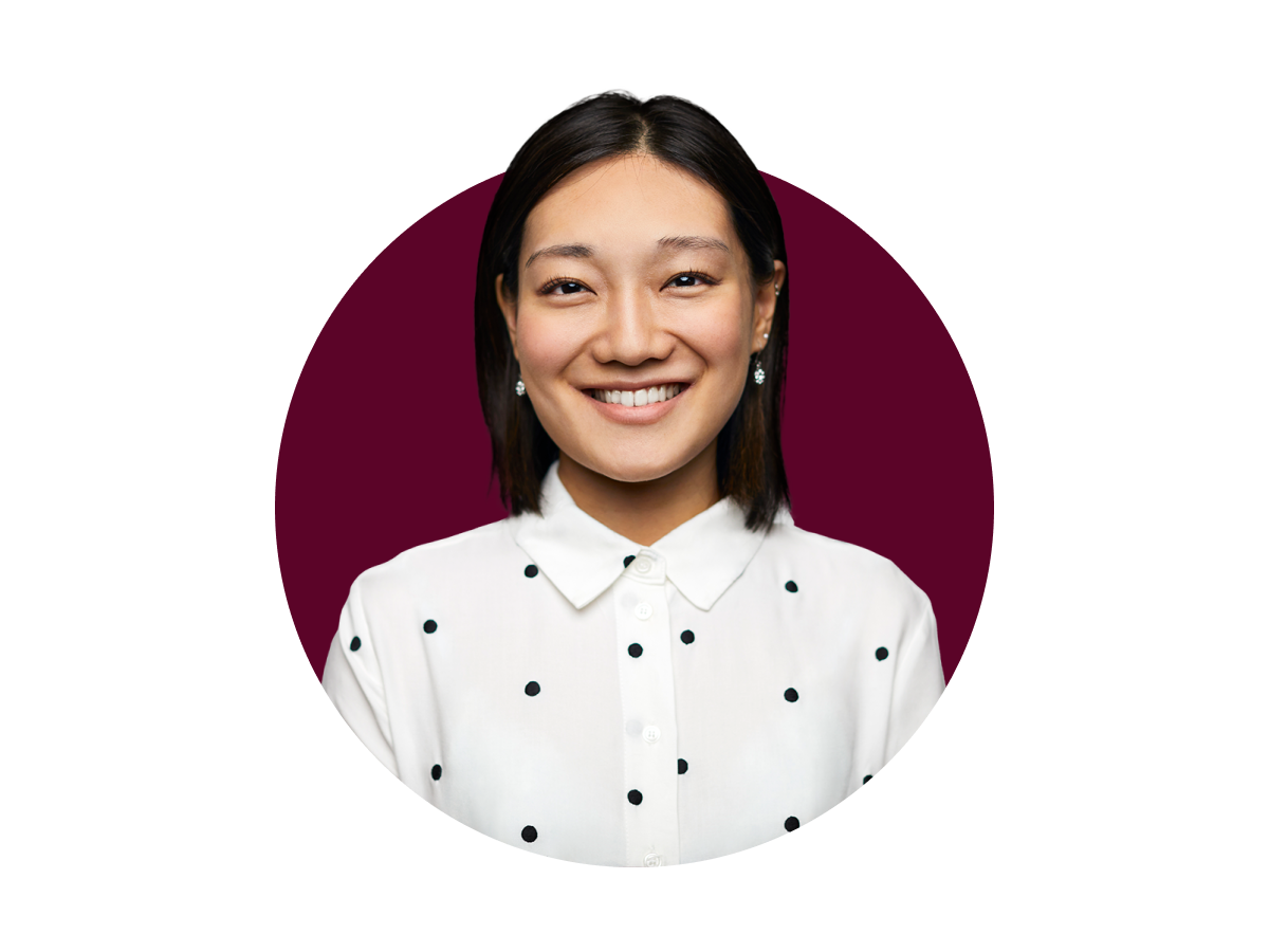 Smiling person in a polka dot shirt
