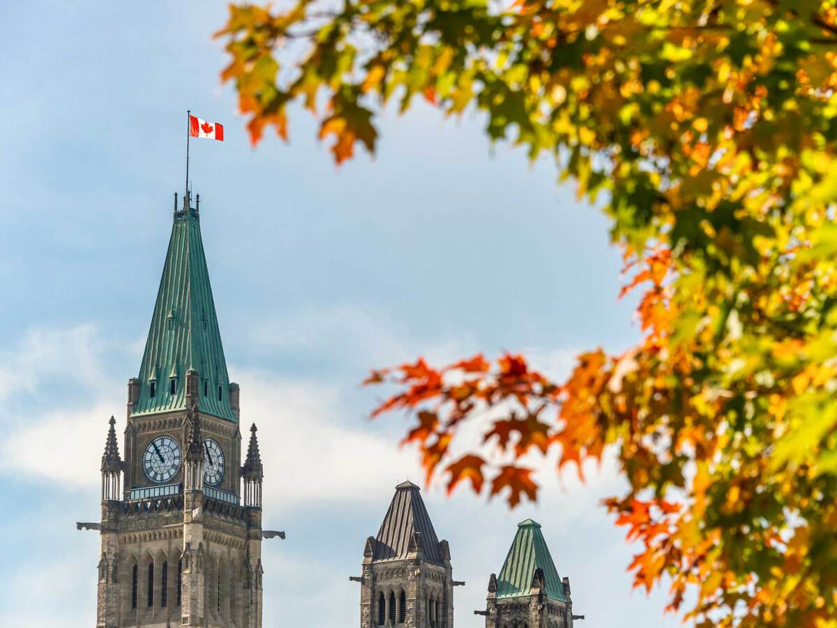 Peace Tower of the Canadian Parliament with autumn foliage in Ottawa