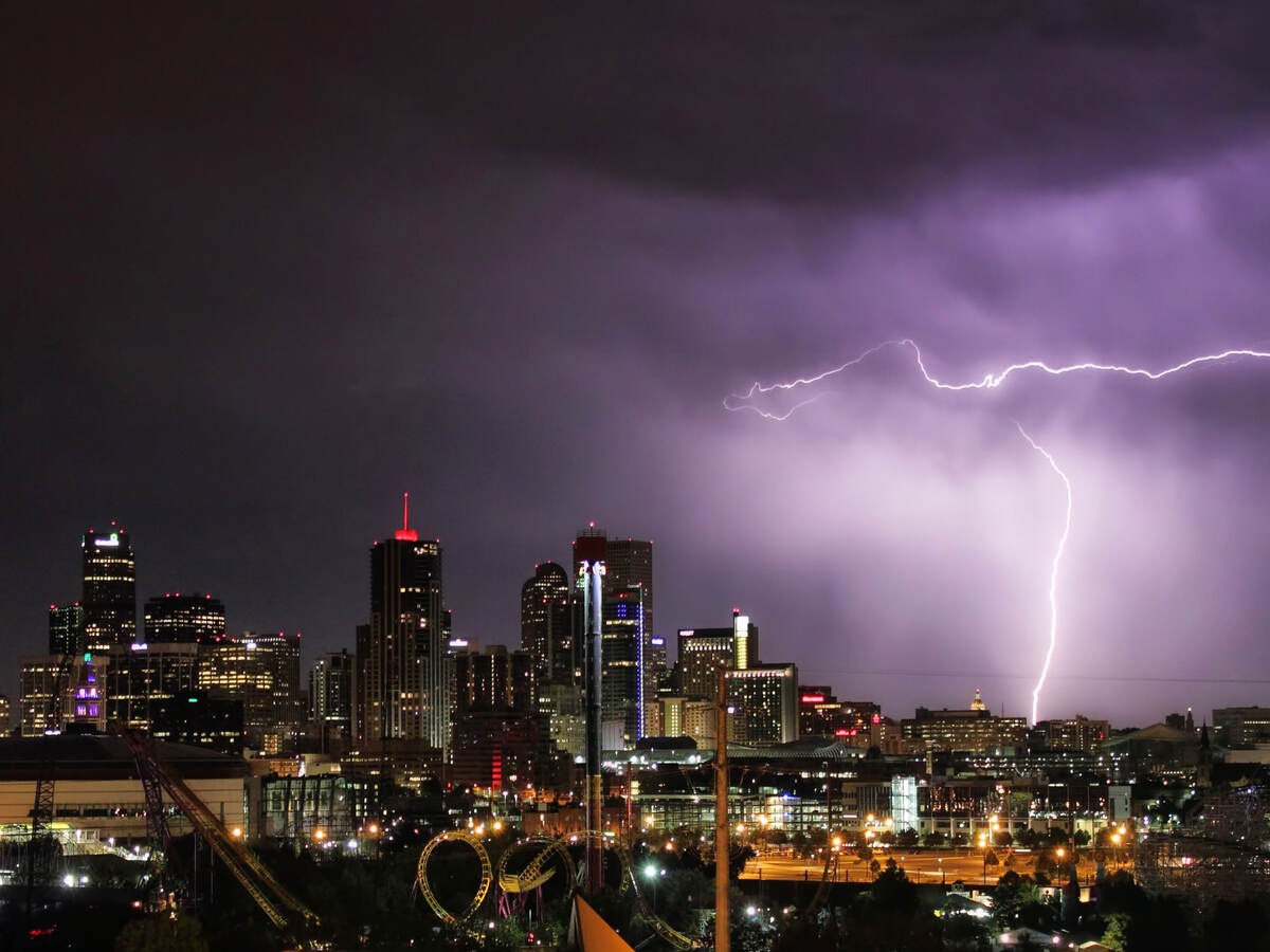 A lightning storm behind a city 