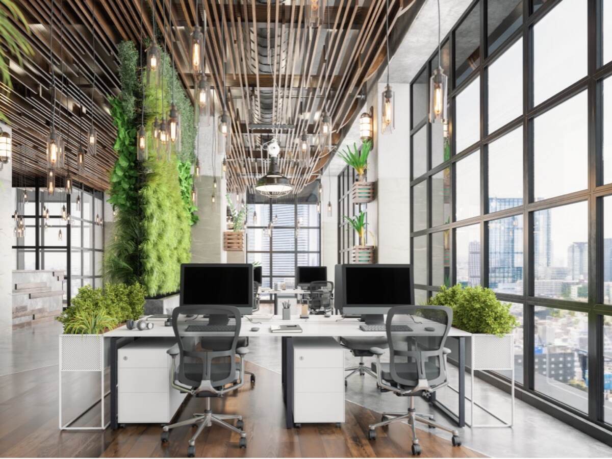 Interior of modern open office with lots of windows, green plants, lighting and visible HVAC/air system