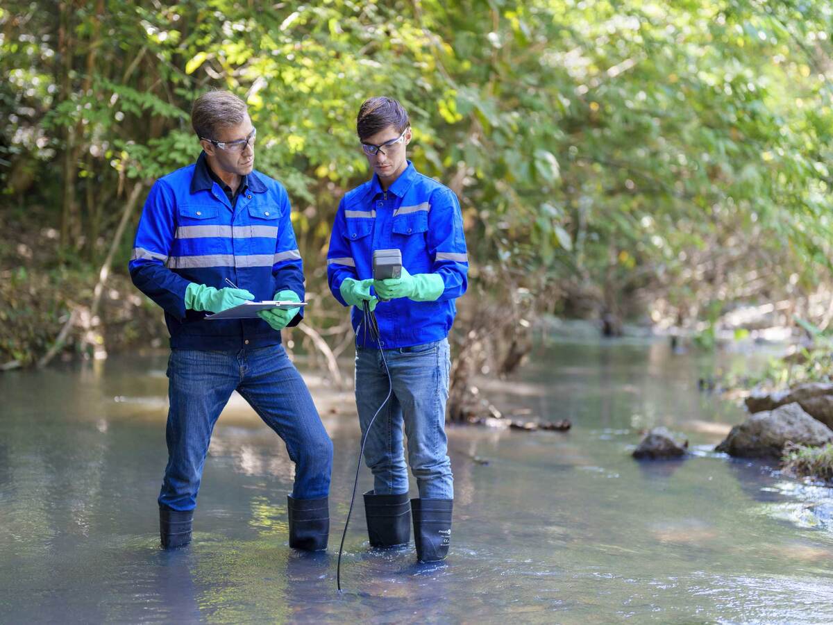 Environmentalists taking water samples in a creek