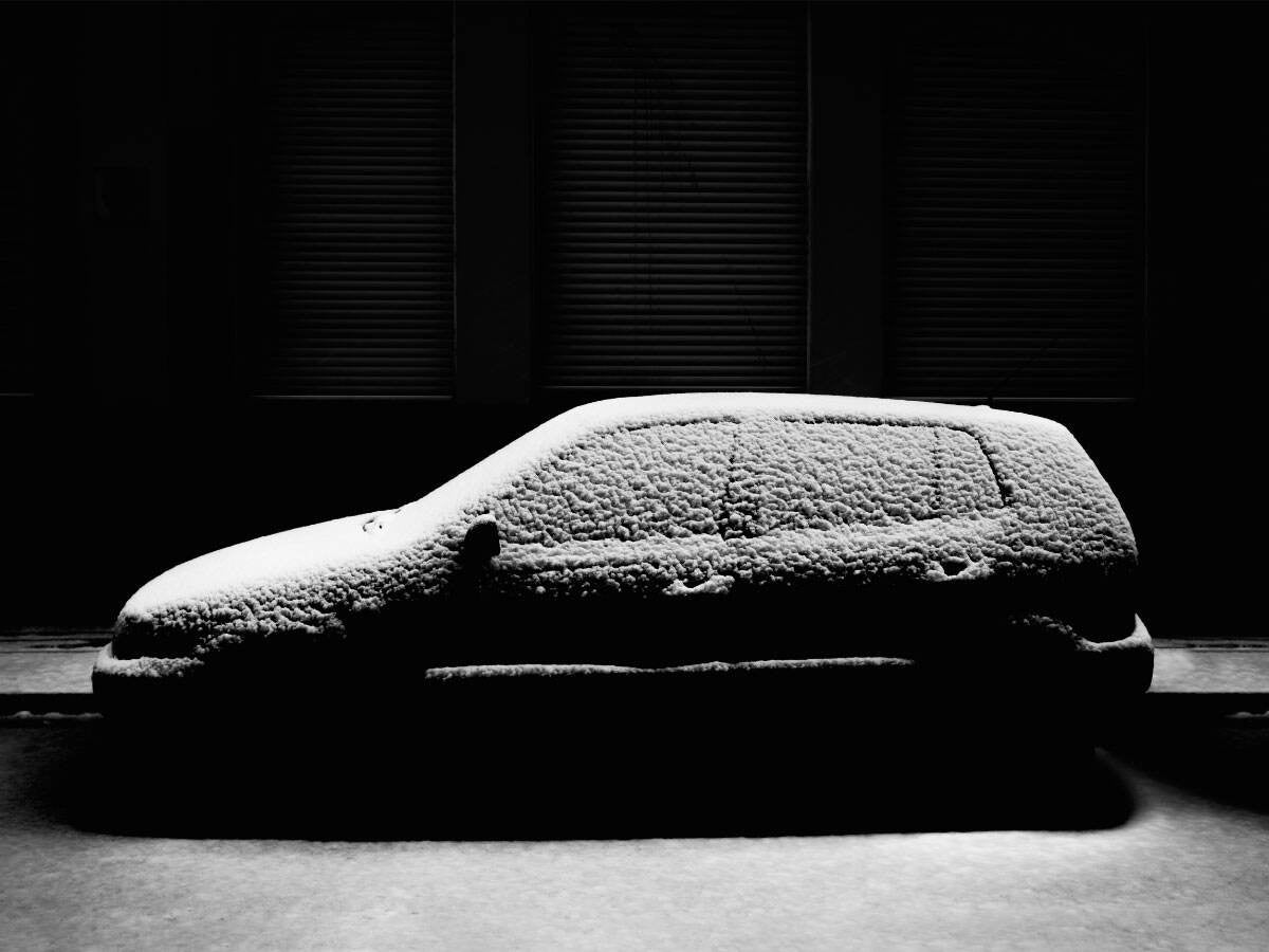 a black SUV lightly covered with snow
