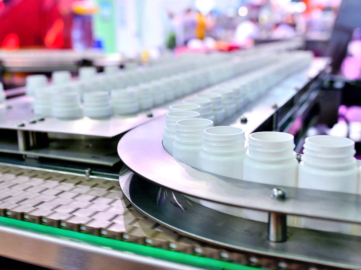 White plastic bottles on a production line