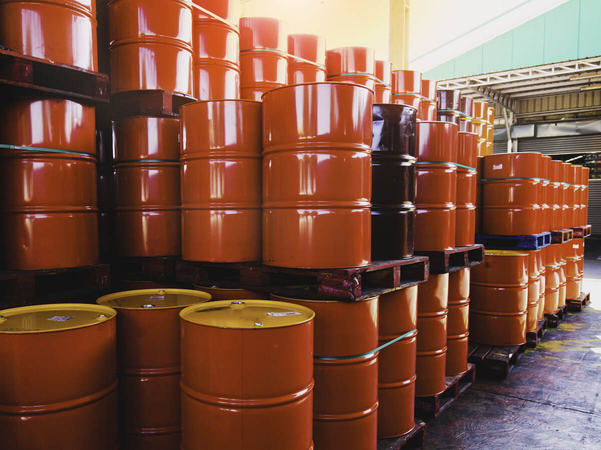 Stacks of red oil barrels in a warehouse