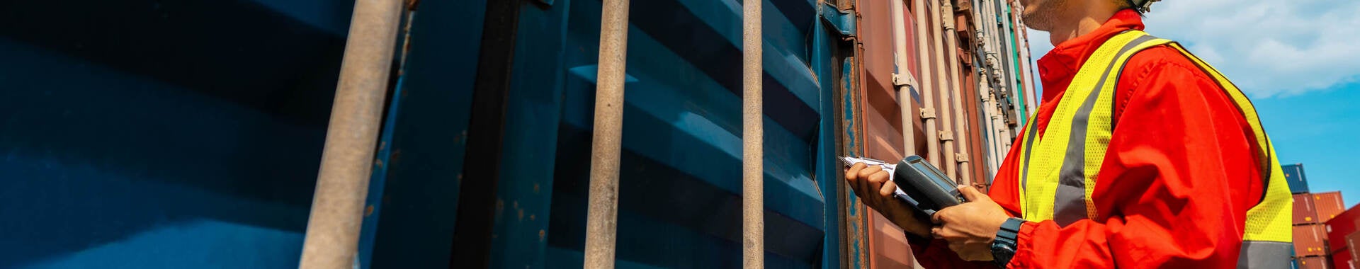 Man looking at shipping containers