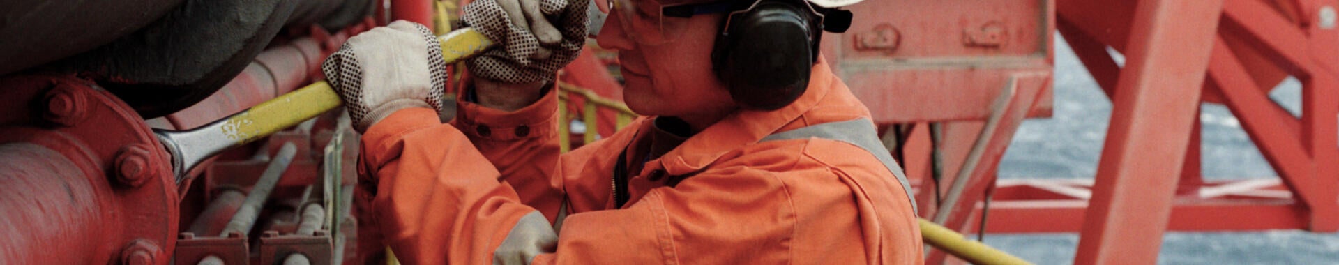 Working in a hard hat working in a petroleum refinery