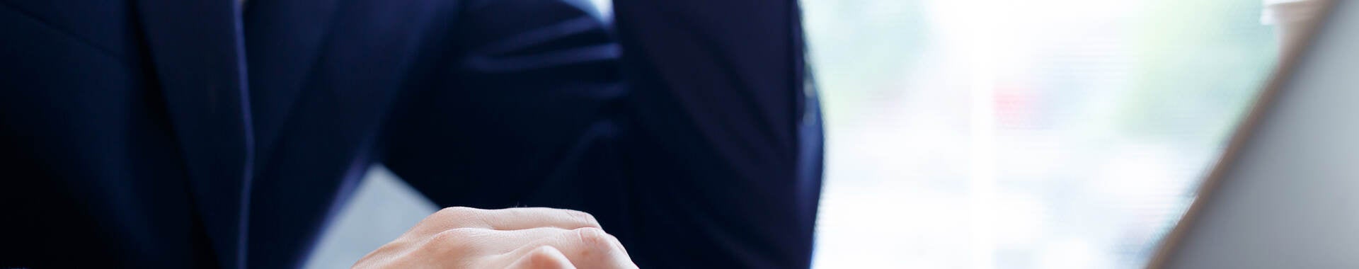 Man in a suit using a laptop