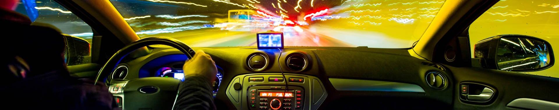 Car interior lights and exterior traffic lights on the roadway