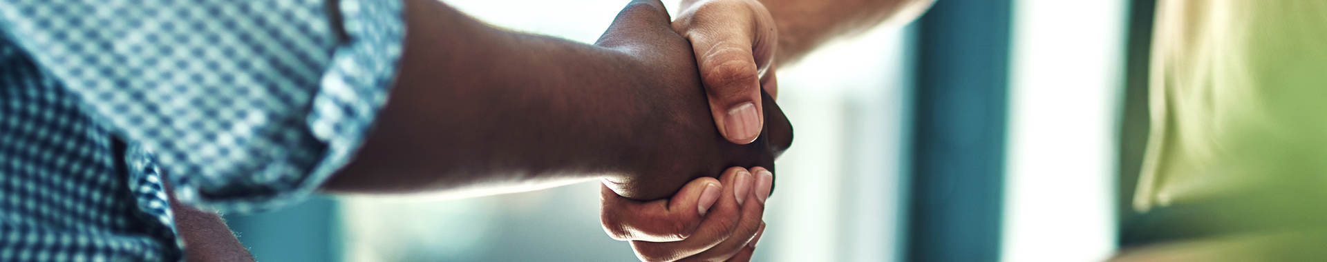 A black man and white man shaking hands