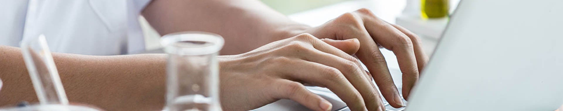 Scientist typing on laptop