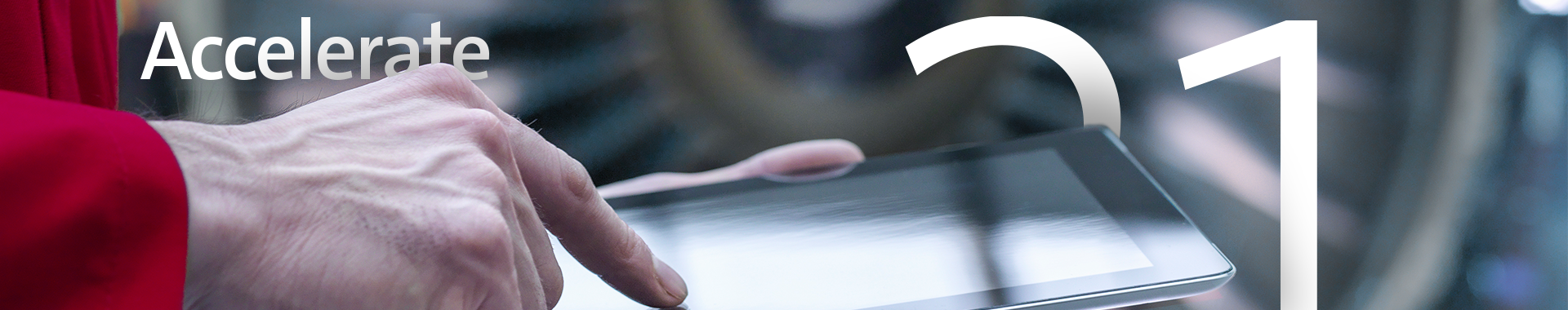 closeup of hand on tablet with jet engine out of focus in background with text Accelerate and 21