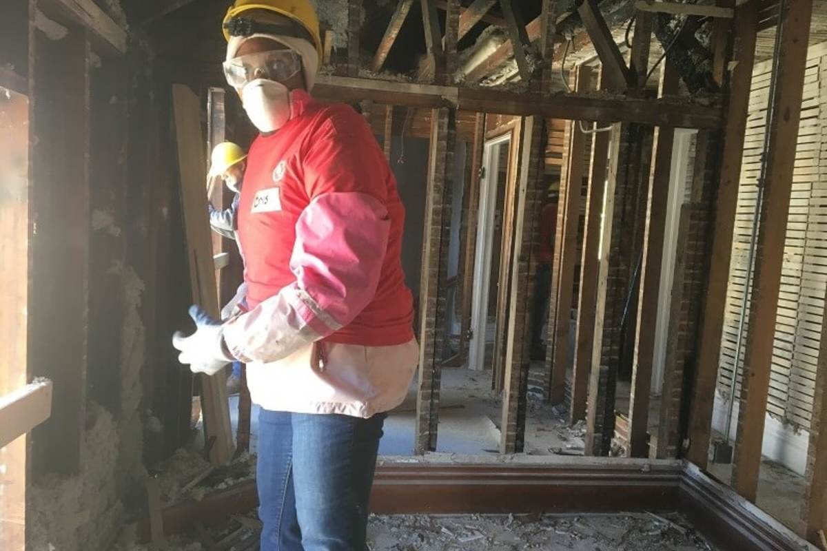 UL volunteer takes a break from clearing out interior materials