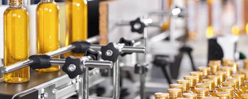 Bottles filled with liquid moving through the manufacturing process.