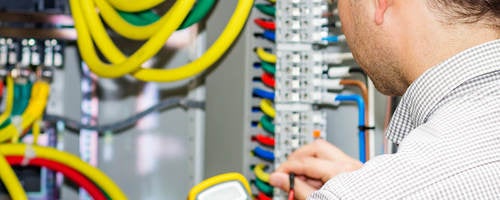 Electrical engineer working in electrical cabinet