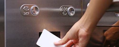 A worker scans an identification card to access an access control system